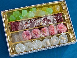 Box of varied flavors Angoori Petha or Petha kept on a dark background. Side lit,top view.Agra,India.