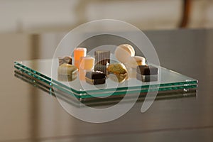 Petit fours on a modern glass plate