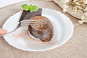 Petit gateau delicious chocolate dessert, fluffy cake with melted chocolate cream inside.