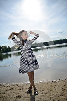 Petite woman wearing dress at lake