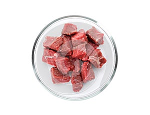 Petri dish with pieces of raw cultured meat on white background, top view