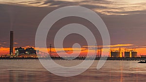 Petrochemical plant in night time with reflection over the river