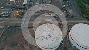 Petrochemical plant tanks top view. Drone flying over industrial infrastructure