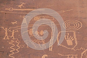 Petroglyphs of stick figures and spiral from Atlati Rock, NV photo