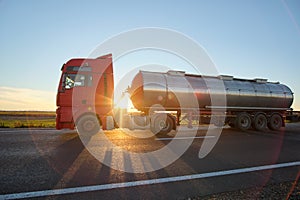 Petrol cargo truck driving on highway hauling oil products. Delivery transportation and logistics concept