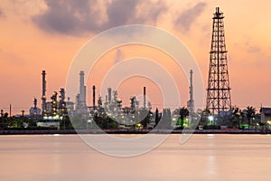 Petrol chemical refinery industry plant waterfront, dramatic sky during sunrise