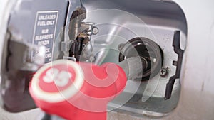 A petrol filling gun is inserted into the vehicle`s tank.