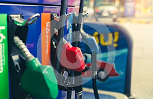 Petrol pump filling fuel nozzle in gas station. Fuel dispenser. Refuel fill up with petrol gasoline. Gas pump handle. Red petrol