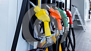 Petrol pump filling fuel nozzle in gas station. Fuel Pump, Gas Station, Gasoline. Colorful Petrol pump filling nozzles