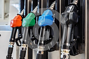 Petrol pump filling nozzles at a gas station