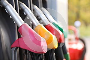 Petrol pump filling nozzles at gas station, closeup