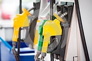 Petrol pump filling nozzles at the gas station in a service