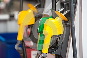 Petrol pump filling nozzles at the gas station in a service
