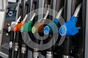 Petrol pump filling nozzles at station gas