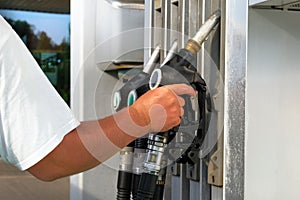 Petrol station pump. Man fills up his car with a gasoline at gas station. To fill car with fuel. Gasoline and oil products