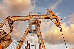 Petroleum concept. Oil pump rig. Oil and gas production. Oilfield site. Pump Jack are running. Drilling derricks for