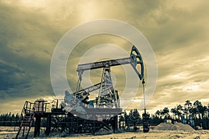 Petroleum concept. Oil pump rig. Oil and gas production. Oilfield site. Pump Jack are running. Drilling derricks for