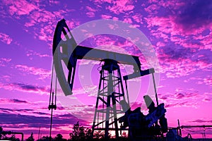 Petroleum concept. Oil pump rig. Oil and gas production. Oilfield site. Pump Jack are running. Drilling derricks for