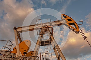 Petroleum concept. Oil pump rig. Oil and gas production. Oilfield site. Pump Jack are running. Drilling derricks for