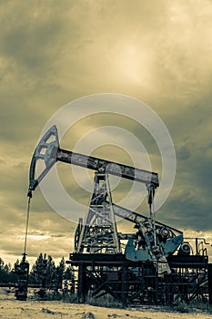 Petroleum concept. Oil pump rig. Oil and gas production. Oilfield site. Pump Jack are running. Drilling derricks for