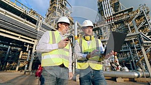 Petroleum experts are using gadgets on the plant premises