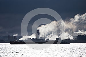 Petroleum gas container ship and oil refinery background for energy nautical transportation .