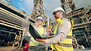 Petroleum refinery inspectors are discussing industrial project