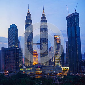 Petronas Twin Towers fondly known as KLCC and the surrounding buildings at evening
