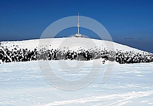 Petrovy kameny and Praded hill with TV transmitter in winter Hruby Jesenik mountains