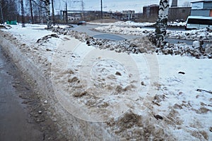 Petrozavodsk, Russia, 01.15. 2023 Snow, ice, slush and winter mud on the sidewalk. The air temperature is about 0