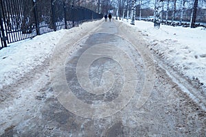 Petrozavodsk, Russia, 01.15. 2023 Snow, ice, slush and winter mud on the sidewalk. The air temperature is about 0