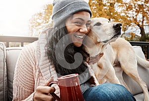 Pets make our lives whole. a young woman relaxing with her dog outside.