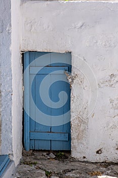 Petunia flowers in a yellow pot on a blue window sill, Cyclades Greece