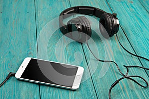 phablet and headphones on the wooden desk photo