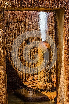 Phallic shape tube with strong stream splashing water to the air in natural spring in Damia, Morocco photo