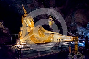 PHANG NGA, THAILAND,Wat Tham Suwan Khuha cave. Golden statue of Buddha of Nirvana in buddhist cave temple in Wat Tham Suwankhuha