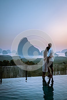 Phanga bay viewpoint, couple watching sunrise on the edge of a swimming pool, infinity pool looking out over Phangnga