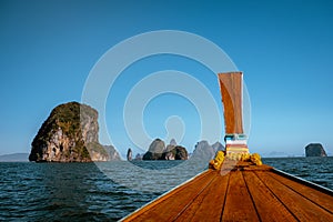 Phangnga Bay ocean with green Island on a beautiful day with blue sky, longtail boat sail on ocean in Thailand