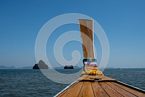 Phangnga Bay ocean with green Island on a beautiful day with blue sky, longtail boat sail on ocean in Thailand