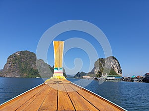 Phangnga Bay ocean with green Island on a beautiful day with blue sky, longtail boat sail on ocean in Thailand