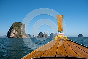 Phangnga Bay ocean with green Island on a beautiful day with blue sky, longtail boat sail on ocean in Thailand