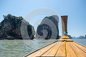 Phangnga Bay ocean with green Island on a beautiful day with blue sky, longtail boat sail on ocean in Thailand