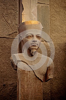 Pharaoh statue in the ancient ruins of the Temple of Karnak in Luxor, Thebes, Egypt