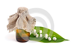 Pharmaceutical bottle and lily of the valley. photo