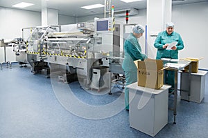 Pharmaceutical factory workers in sterile environment