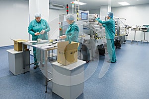 Pharmaceutical factory workers in sterile environment