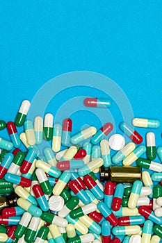 Pharmaceutical and health concept, Variety of antibiotic capsules on light blue background