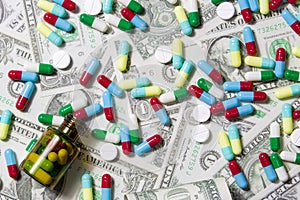 Pharmaceutical and health concept, Variety of antibiotic capsules and pills on dollar background