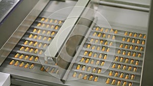 Pharmaceutical industry close up. Pills and tablets production. Medical factory equipment