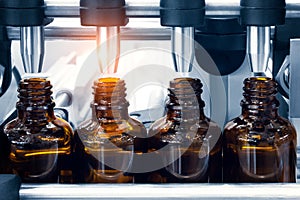 Pharmaceutical industry, medicine pills are filling in the  bottle on production line machine conveyor at the medical factory.